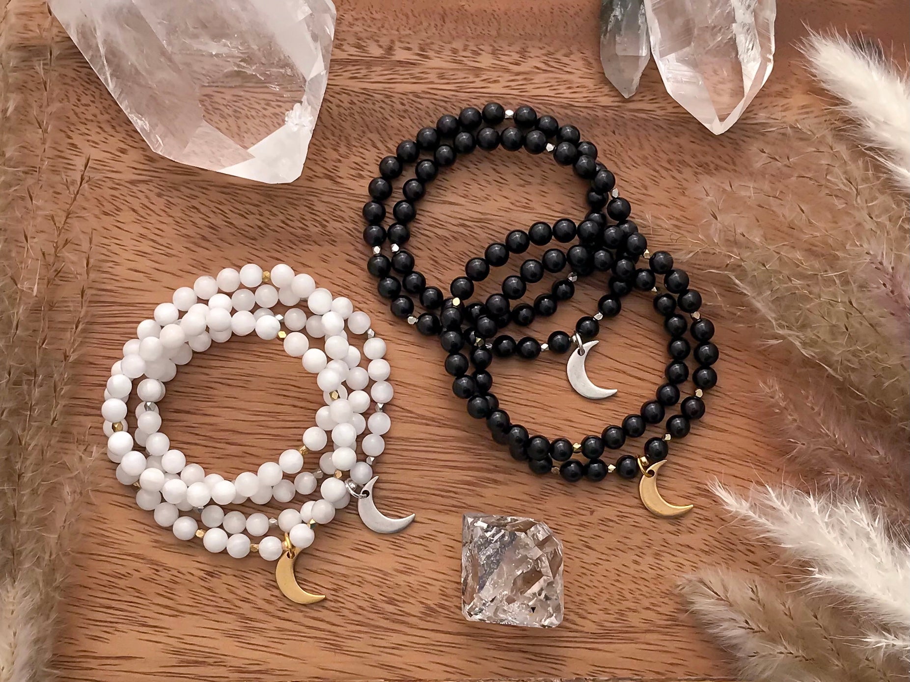 LUNA Mala Wrap Bracelet Collection. Moonstone bracelet with Crescent Moon charm and diamond cut accents. Black tourmaline bracelet with gold or silver Moon charm and diamond cut accents. Available in gold or silver.