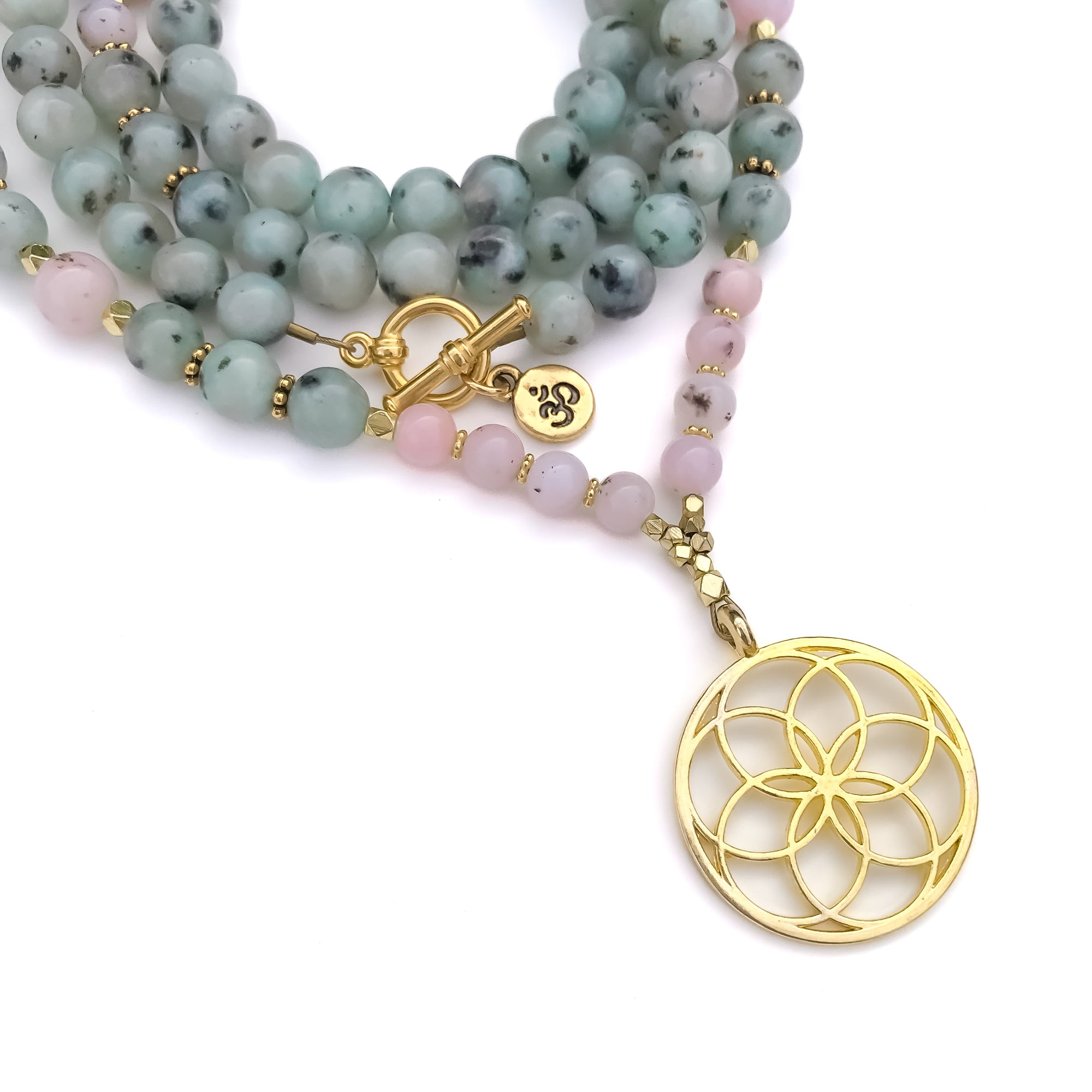 Mala Necklace with green Sesame Jasper and pink opal beads and a gold flower pendant on a white background