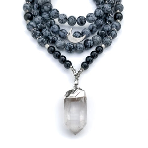 Beaded Necklace with snowflake obsidian and black onyx , a clear quartz crystal pendant, silver accents and silver moon charm.