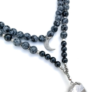Natural crystal beads mala necklace made with snowflake obsidian and Black onyx. Adorned with clear quartz pendant and silver moon charm.