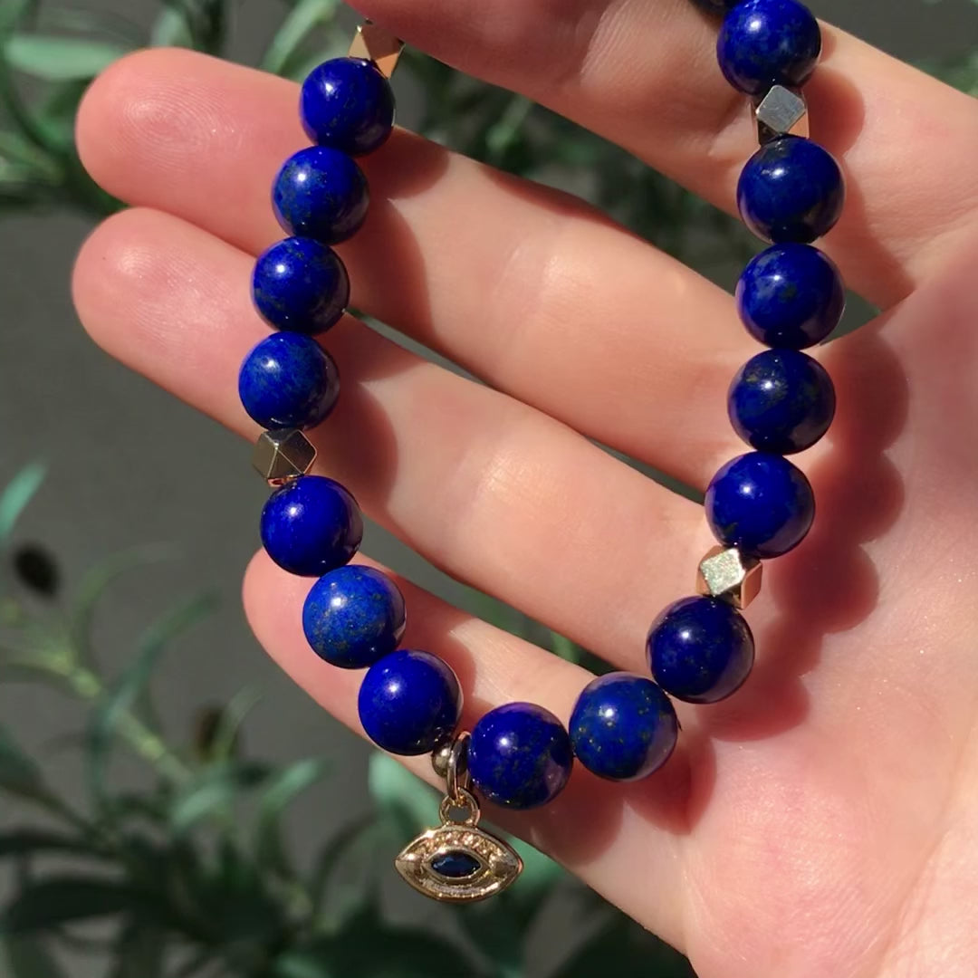 Lapis Lazuli mala bracelet with gold evil eye charm and gold faceted accents, spiritual jewelry by Mishka Samuel