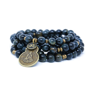 Blue Tiger Eye Mala beads with antique brass details, small Om charm and Quan Yin pendant.