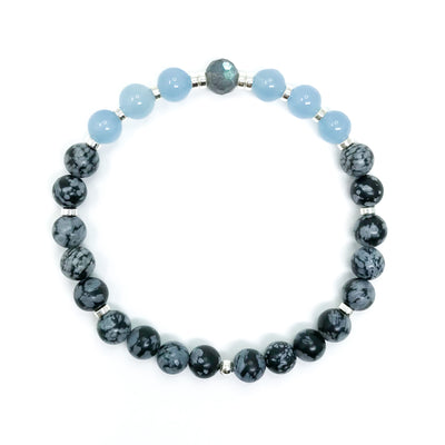 A crystal healing mala bracelet with black Obsidian with snowflake like pattern, light blue Aquamarine and a faceted gray Labradorite focal bead with blue flash. Choose sterling silver or gold accents. Yoga jewelry.