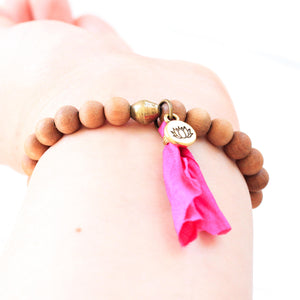 sandalwood prayer bracelet with lotus and tassel